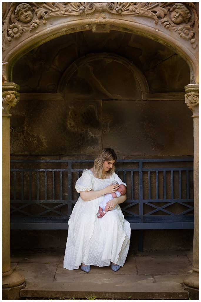 Outdoors newborn photoshoot at Whatton Gardens - mum feeding baby